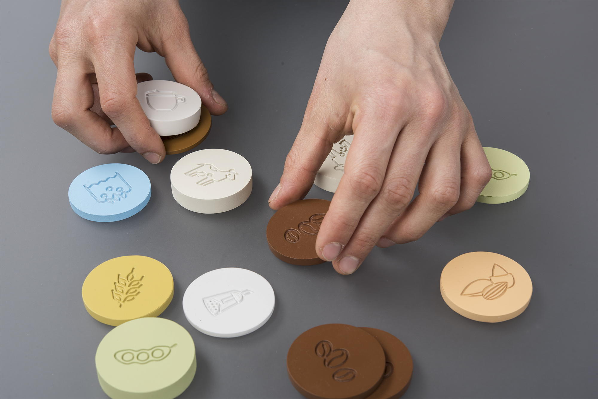 Hands composing a drink with tokens